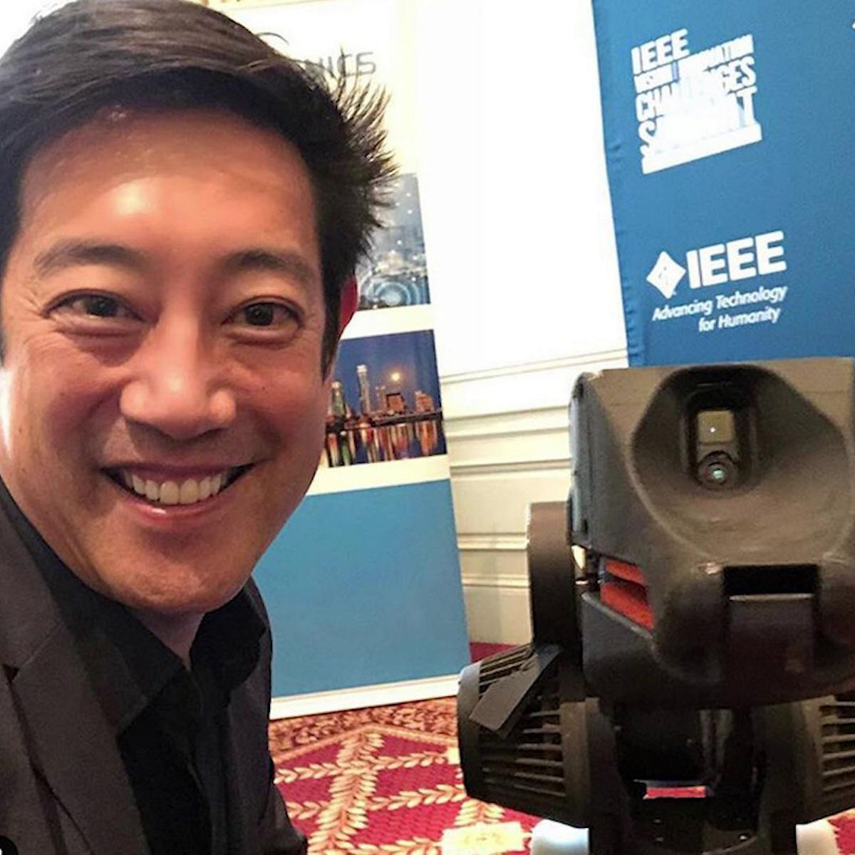 Grant Imahara snaps a selfie with Boston Dynamics' SpotMini robot at IEEE VIC Summit 2018